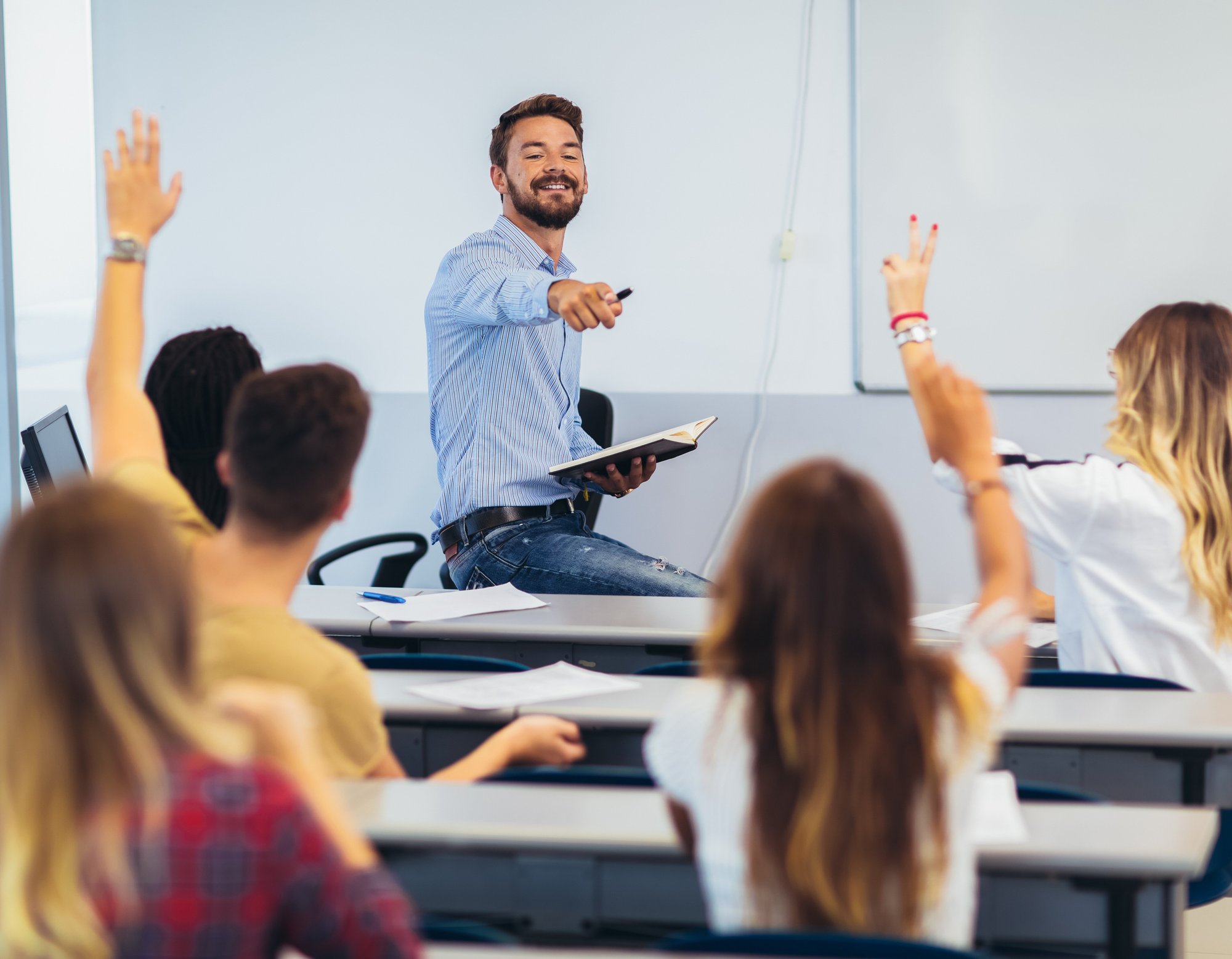 bigstock-Group-Of-Students-Raising-Hand-325701880